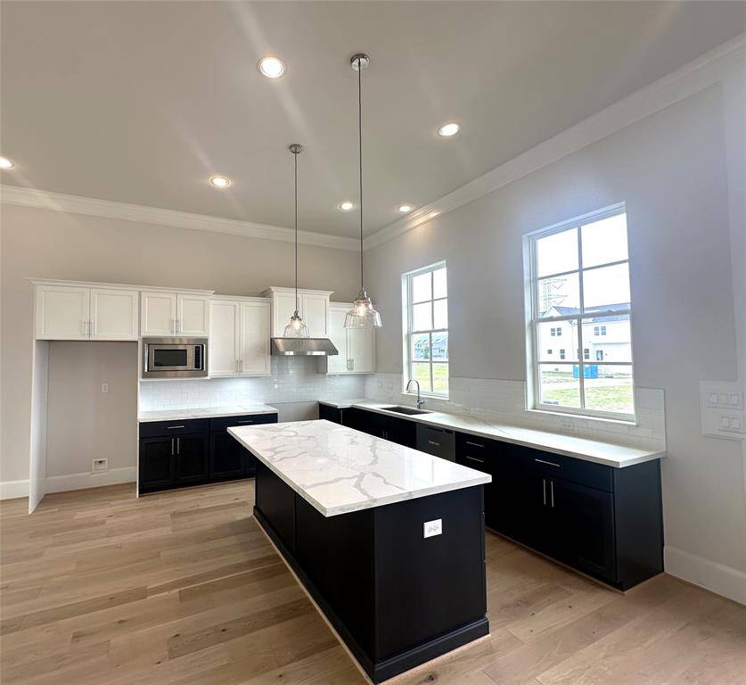 Big and Bright Kitchen - Calcutta Quartz Countertops.  Cabinetry is Furniture Grade - Soft Close Drawers and Doors w/Hardware