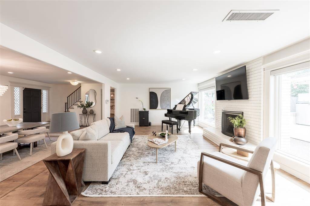 This living area features an open floor plan, a cozy fireplace, and ample natural light.