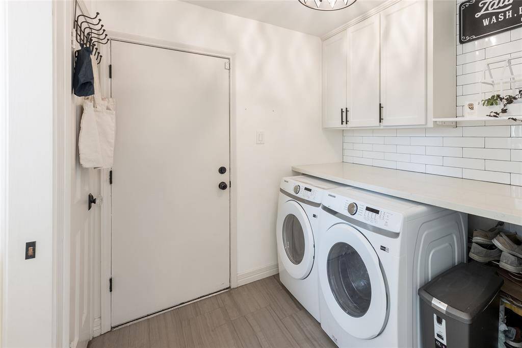 The laundry has built in cabinets, counter top space for laundry, and a half bath to the left side. The laundry room leads to the 3 car garage.