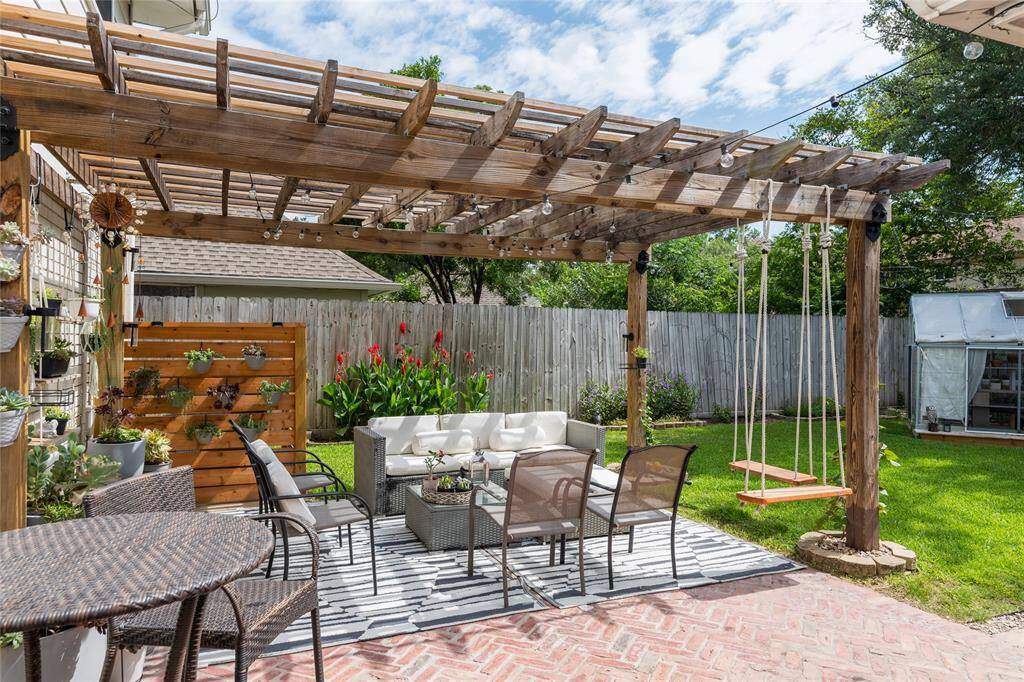 Charming backyard with a wooden pergola providing shade.