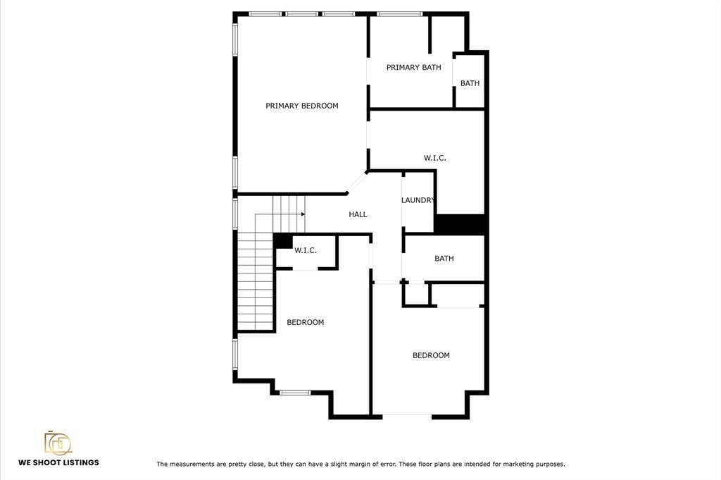 This floor plan features a spacious primary bedroom with an en-suite bath and walk-in closet, two additional bedrooms, two more bathrooms, a laundry area, and a hallway connecting all spaces.