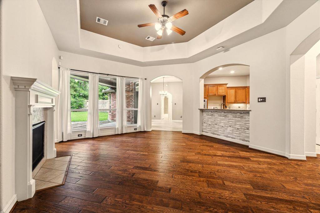 Wall-to-wall windows that fill the space with natural light and offer a seamless view of the backyard.