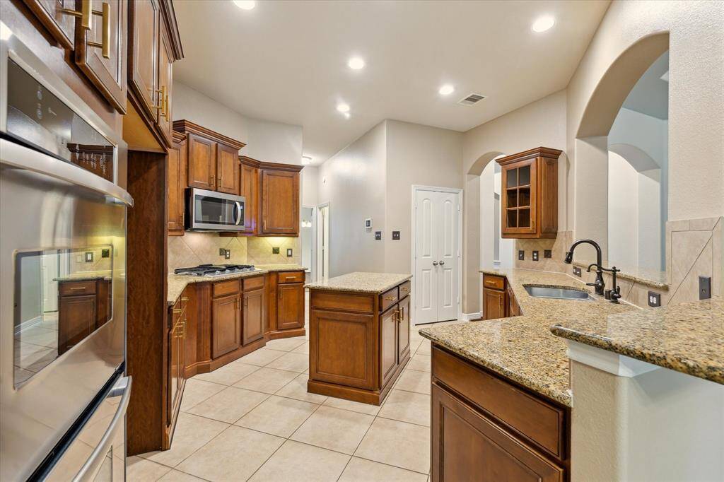 Outfitted with sleek stainless steel appliances and spacious pantry this kitchen delivers style and performance.