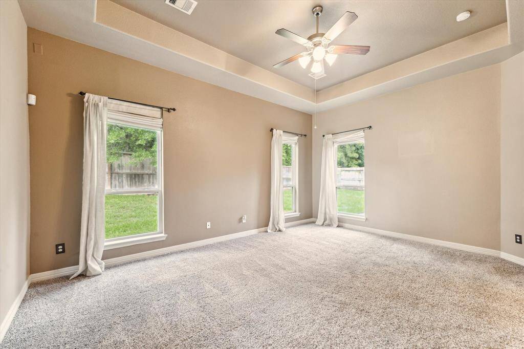 Oversized windows that invite in natural light and serene backyard views.