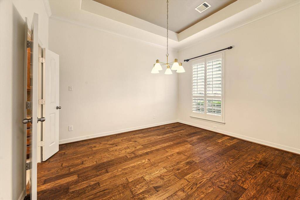 Host in style in this elegant formal dining room featuring hardwood floors, oversized windows that fill the space with light, and French doors offering a seamless transition to the kitchen. Perfect for dinner parties, holidays, and unforgettable gatherings.