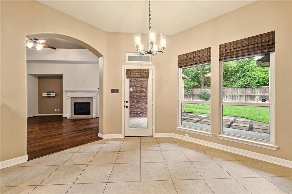 Enjoy morning coffee or casual meals in this light-filled breakfast nook, framed by oversized windows with peaceful backyard views.