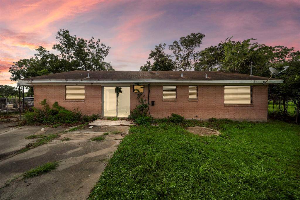 Fancy shutters, windows, and patio doors would transform the back of this home into modern luxury.
