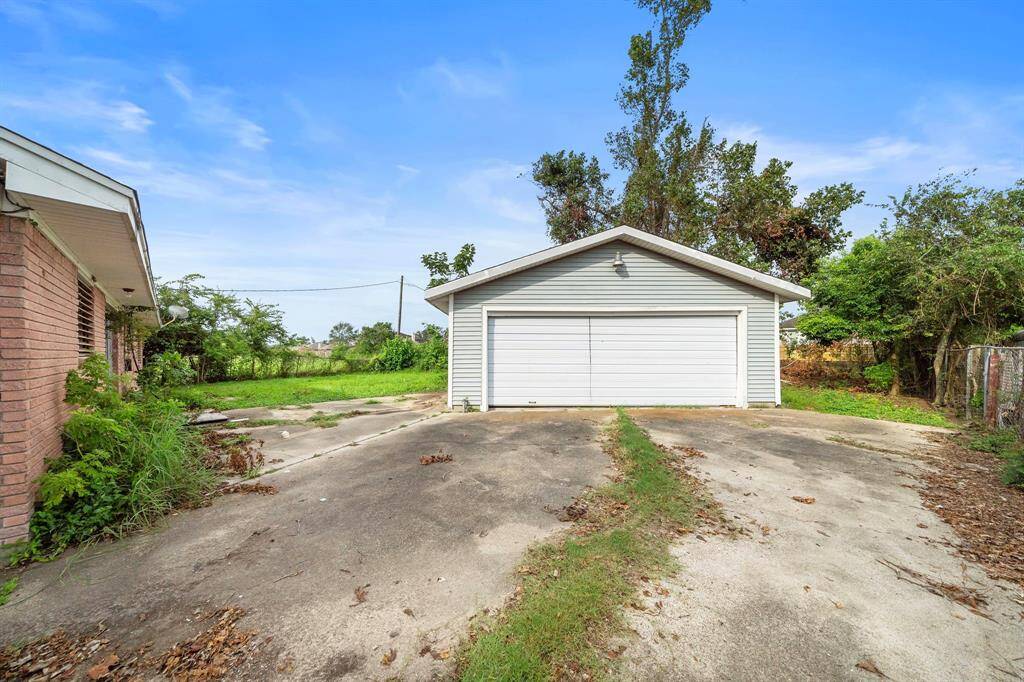 Oversized garage has a workshop.