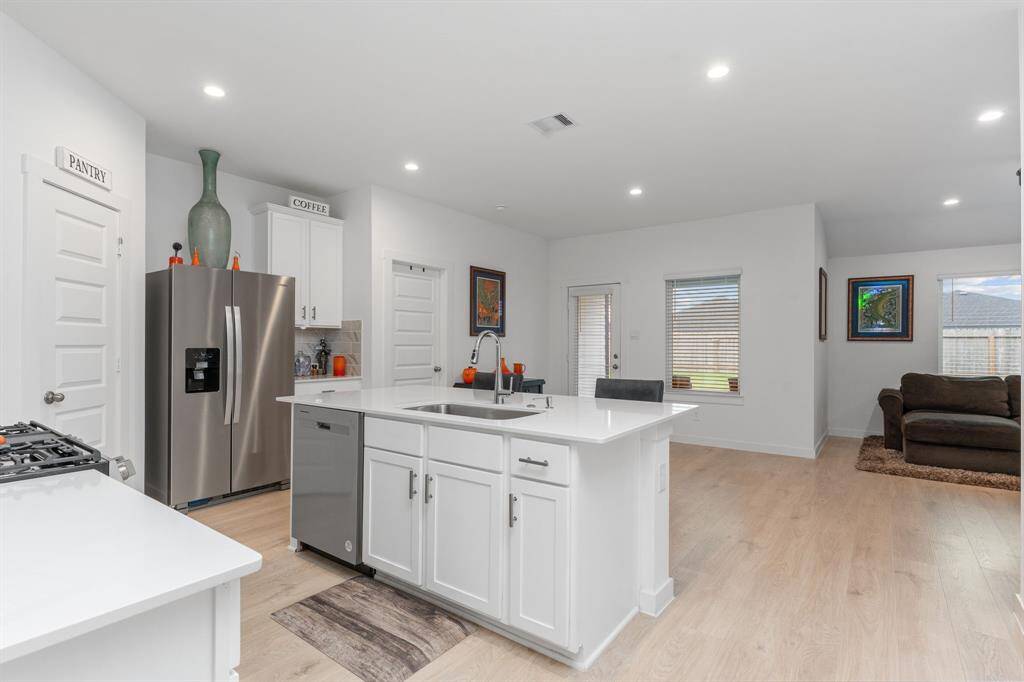 Kitchen featuring ample cabinetry, kitchen island and stainless steel appliances.