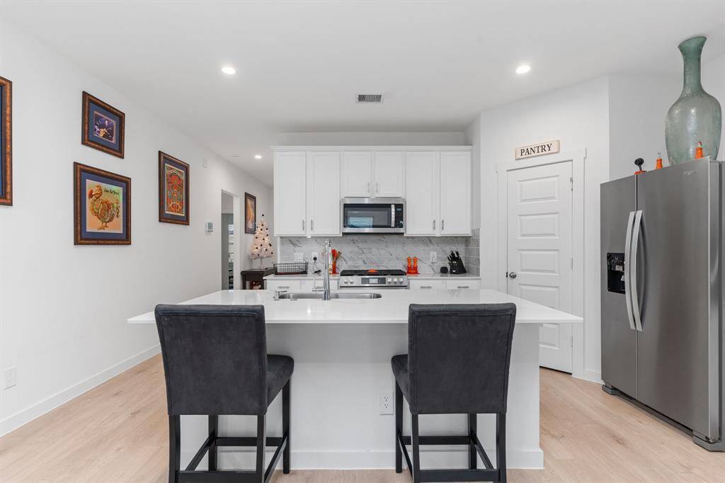 Kitchen featuring ample cabinetry, kitchen island and stainless steel appliances.