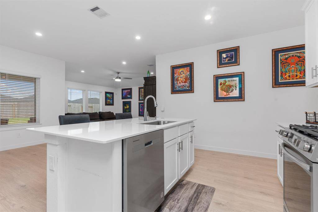 Kitchen featuring ample cabinetry, kitchen island and stainless steel appliances.