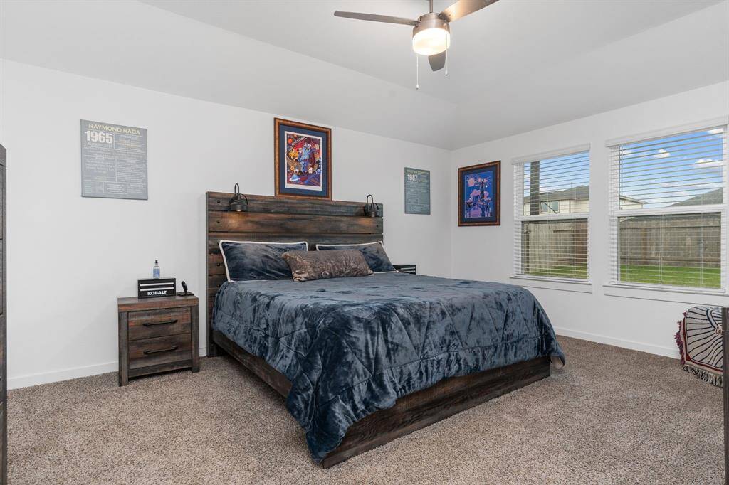 Primary bedroom boasting large windows and en-suite bath.