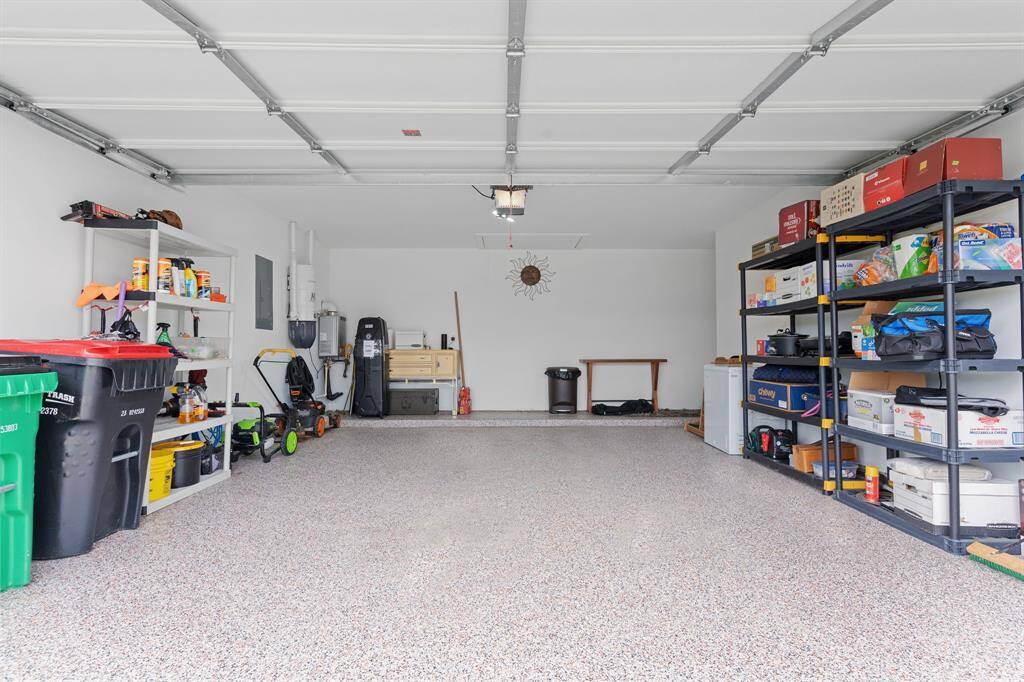 Professionally epoxied flooring in 2 car garage with space for storage.