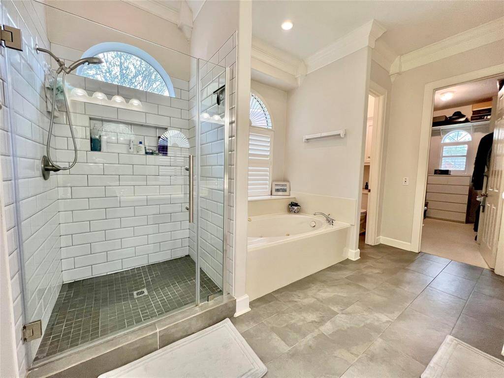The primary bathroom offers a separate shower and tub.