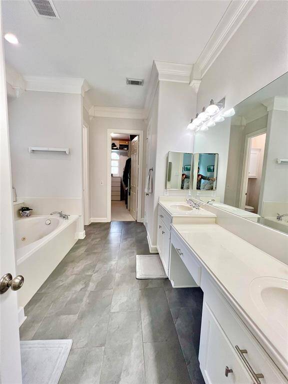 The primary bath offers dual sinks and a vanity.