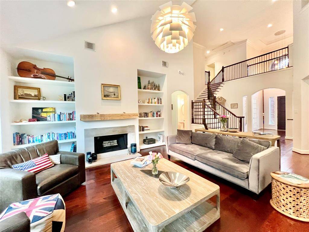 The living room with high ceilings and openness along with a fireplace.