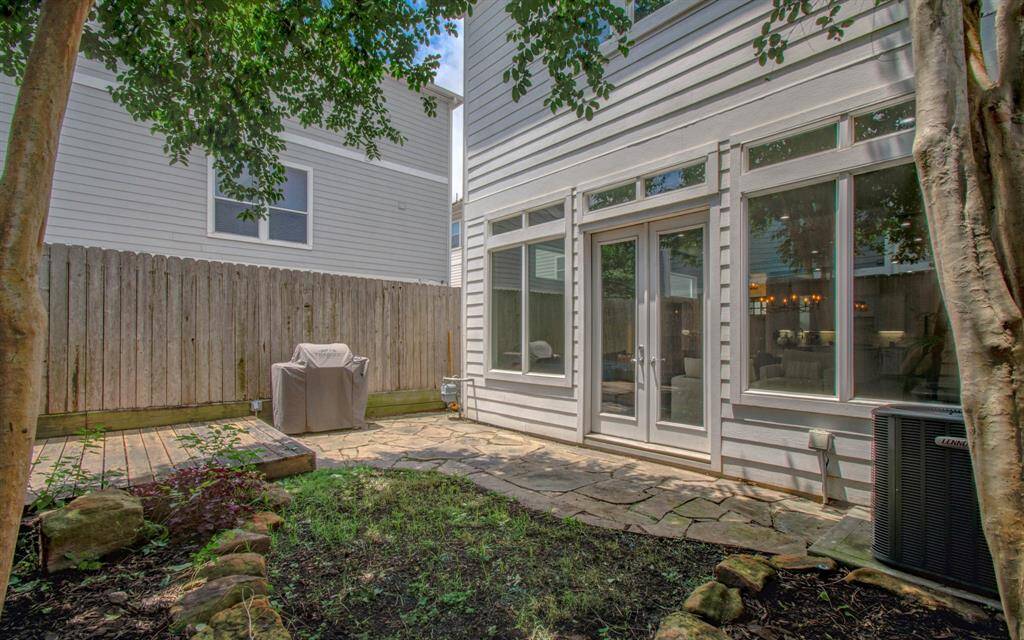 A flagstone path leads to your charming backyard oasis—perfect for pets, kids, or simply unwinding outdoors. In this part of the city, having a true backyard like this is a rare gem!