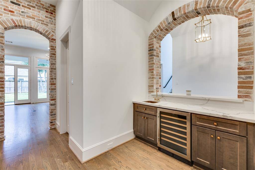 wet bar with wine cooler and sink, large walk-in pantry next to bar