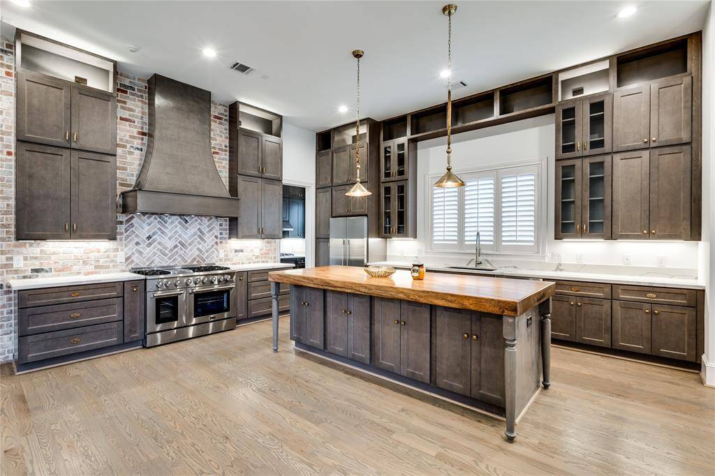 notice the custom built cabinets all the way to the ceiling with decorative shelves