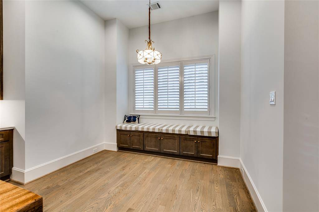 Breakfast room with built-in seating and storage, large window to backyard with wood shutters