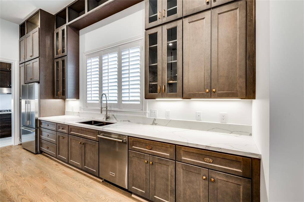 nice counterspace, large window overlooking sink, and stainless steel dishwasher