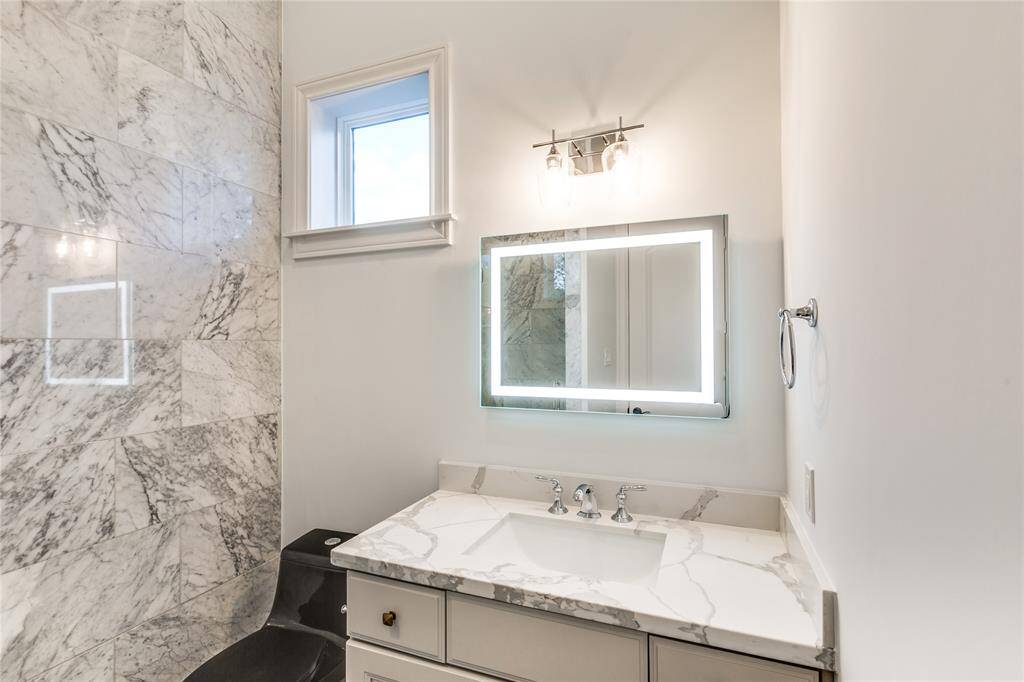 downstair powder room with marble wall and floor