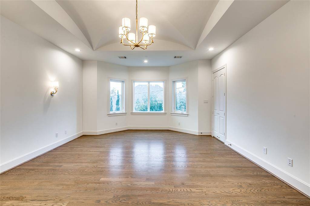 Master bedroom with bay windows and great ceiling design, wood floor