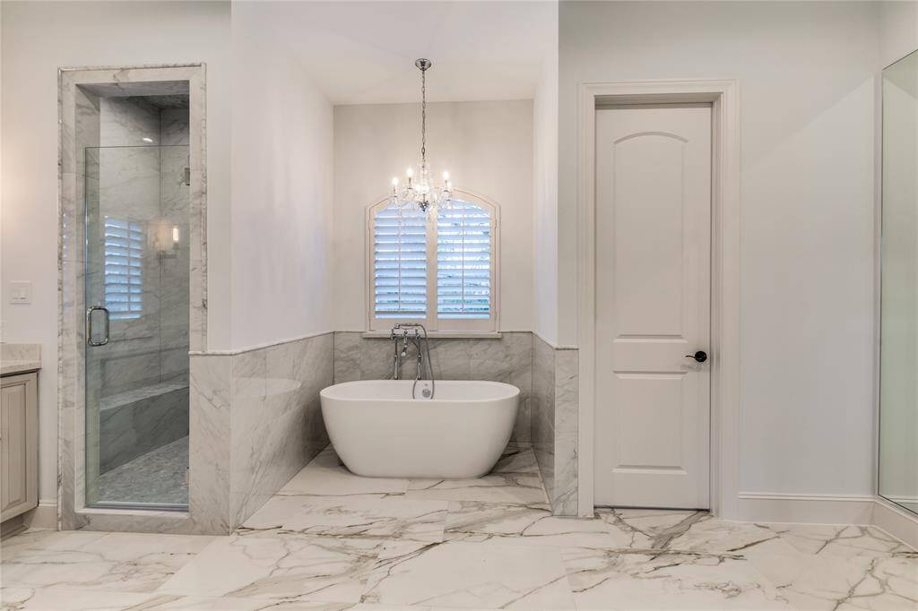 Master bathroom with free standing soak tub and separate toilet room