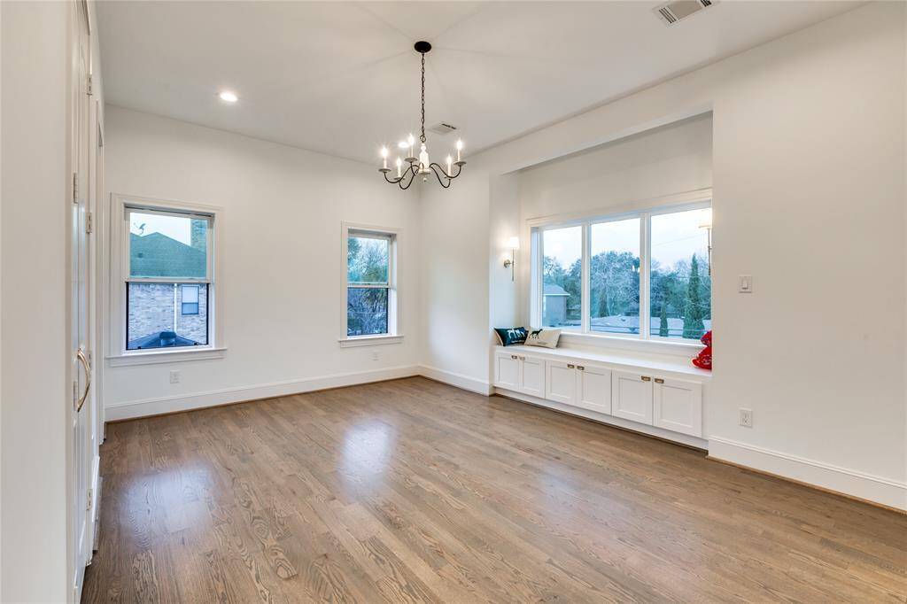 North-west corner bedroom with window seat, big windows, built in storage under window seat, wood shutters, hardwood floor, walk-in closet