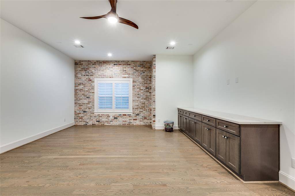 giant game room with built-in, brick accent wall