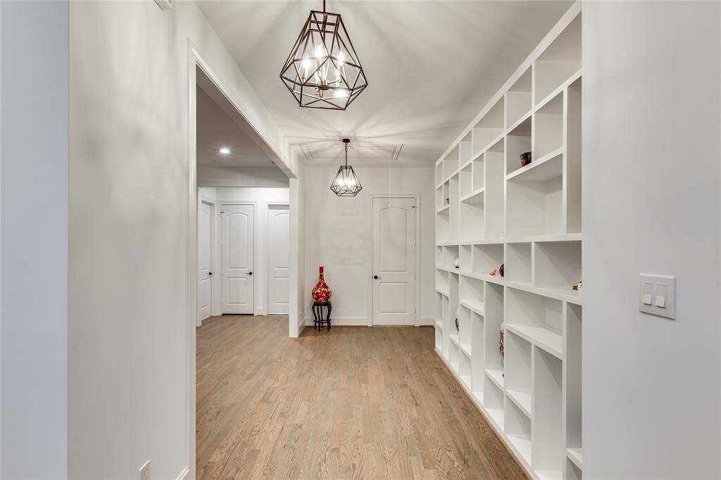 view the second floor hallway/landing from staircase landing, door at end to utility room