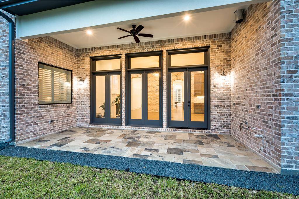 great exterior with stone-covered patio and summer kitchen connections ready (water, gas, vent-hood)