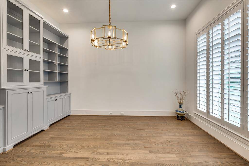 Study or office with custom built-in and wood shutters, 100% brass lighting fixture