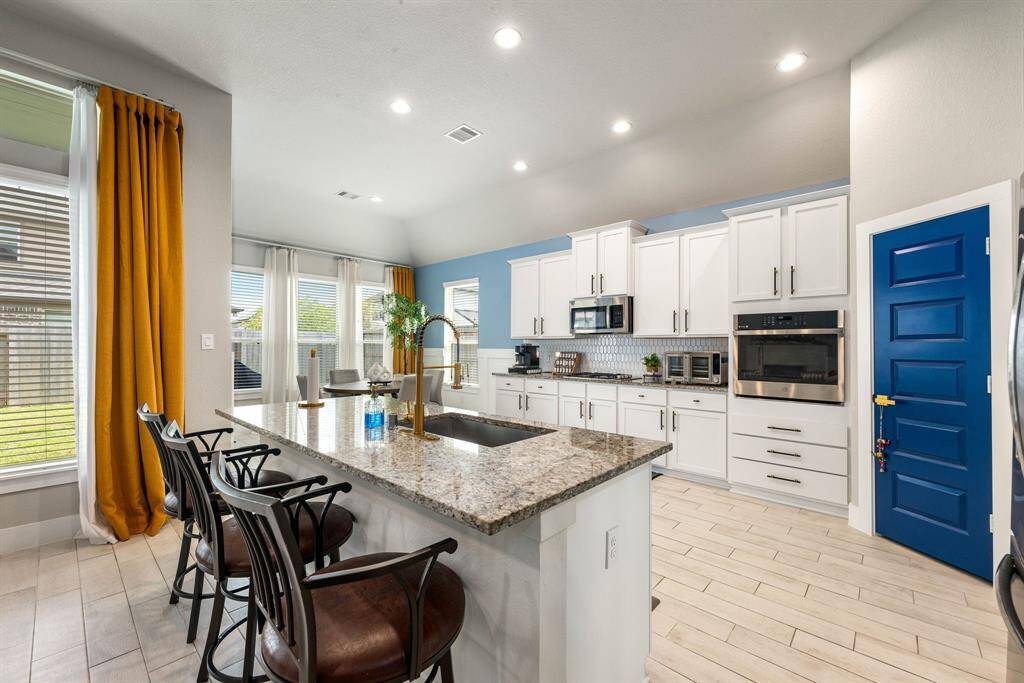 Any chef's dream, this stunning kitchen is perfect for everyday life as well as entertaining family and friends! Extra large kitchen island is perfect for conversation or that much needed space to lay out your party spread for everyone to enjoy! Large windows provide lovely views of your backyard and plenty of natural lighting throughout the day.