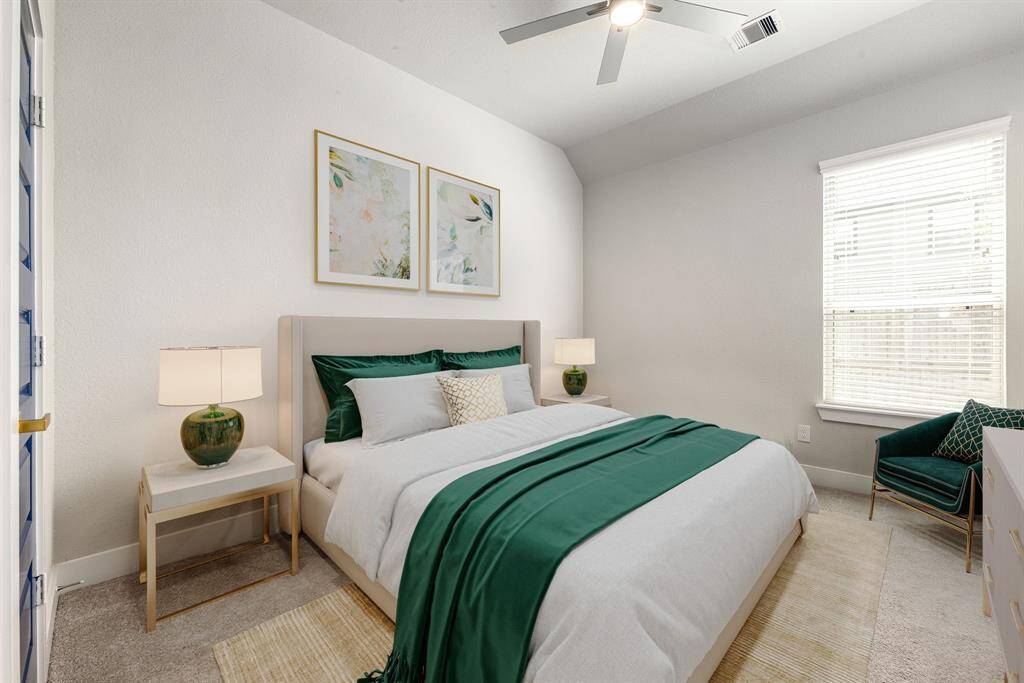 Secondary bedroom great for use as an in-law suite or guest suite features high ceilings, lovely modern ceiling fan, custom paint, plush carpet, space for seating area, direct access to the secondary bathroom and large window with privacy blinds. *Virtually Staged