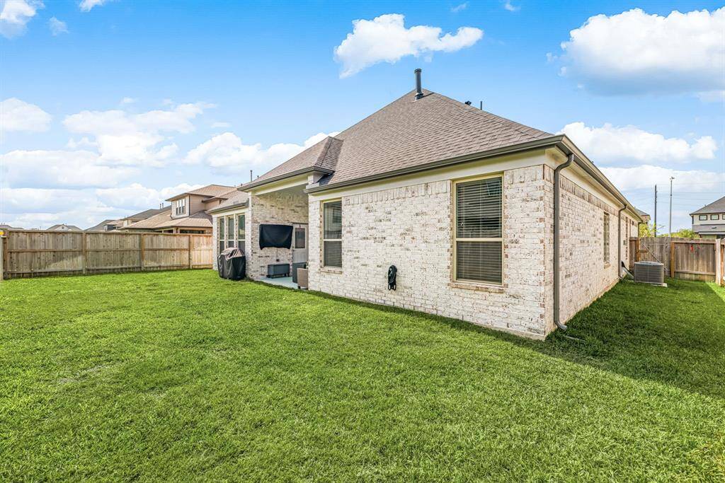 Step into a private backyard oasis with ample green space and a covered patio, ideal for outdoor gatherings or quiet relaxation.