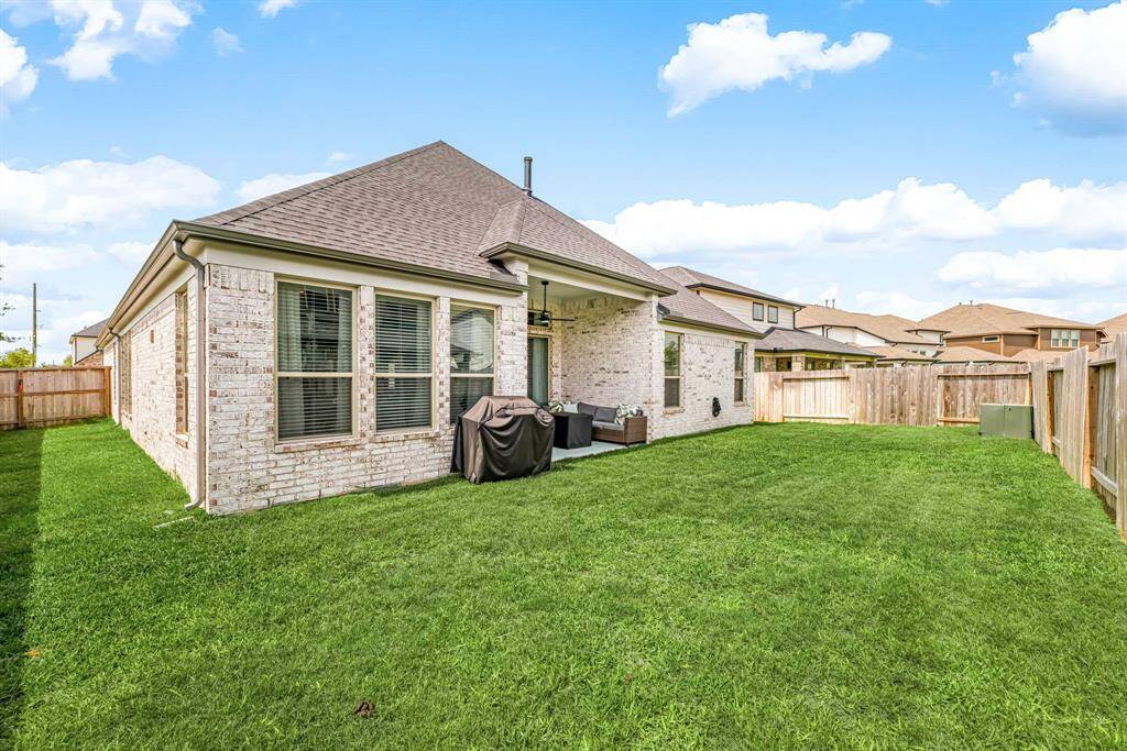 Surrounded by a secure fence, this generous yard offers endless possibilities for play, gardening, or entertaining guests in the fresh air.