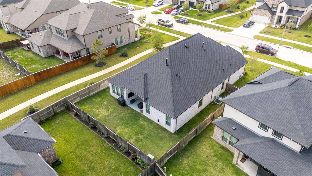 Amazing aerial shot of this gorgeous home situated on a quiet street in the sought after community of Briarwood Crossing zoned to Lamar Consolidated ISD. Lush landscaping, well manicured front lawn and a wonderful back patio perfect to set up an outdoor sitting area.