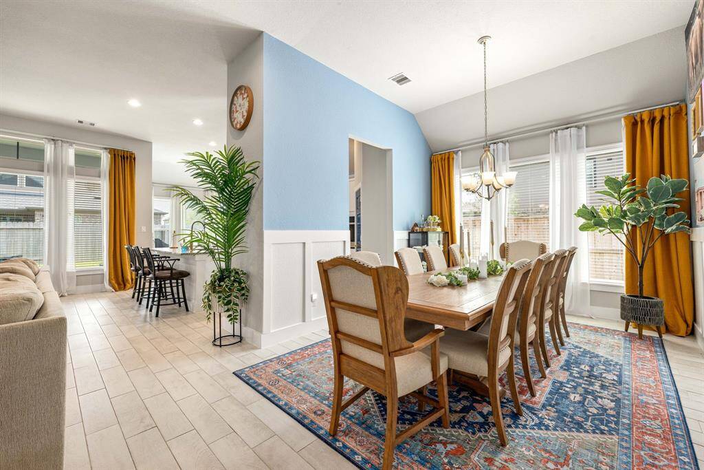 Make memories gathered around the table with your family and friends! This dining room features high ceilings,  large windows, tile flooring and a beautiful chandelier.