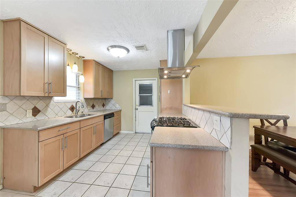 Renovated kitchen features modern finishes, update countertops, and refreshed cabinetry.