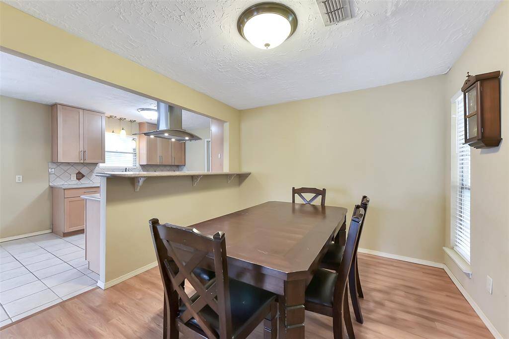 Gather around the table. The open dining space is perfectly positioned off the kitchen and offers room for meals or hosting guests.