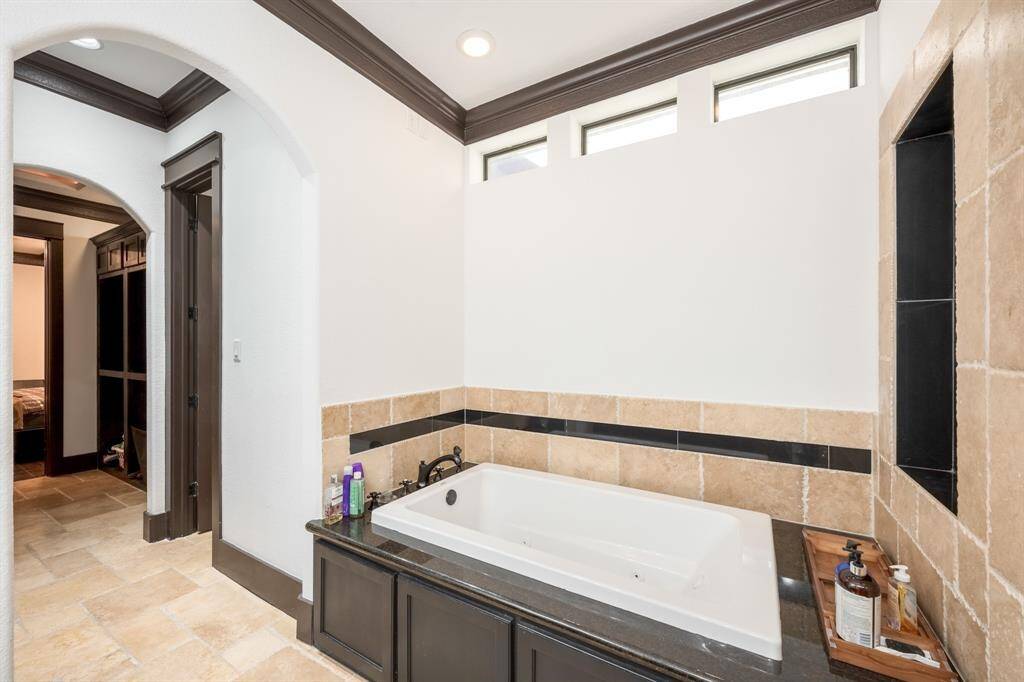 The large jetted tub features windows to keep light throughout and retain privacy as well.