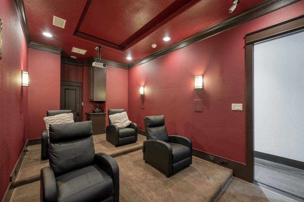 The third floor boasts a movie theatre room with a dry bar, mini-fridge, and a built in screen