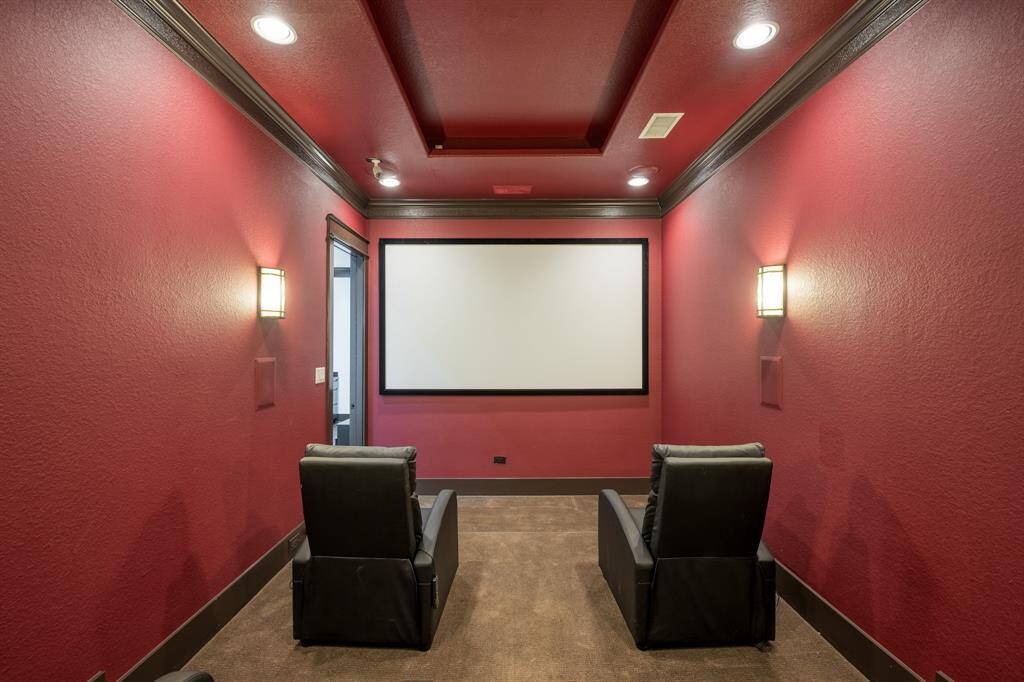 Built in movie screen with recessed lighting and custom light features.