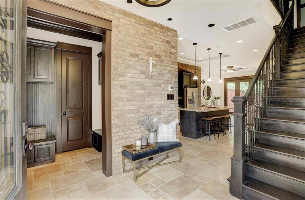 Gorgeous formal entryway accented by a mudroom that pours into a powder room for guests!