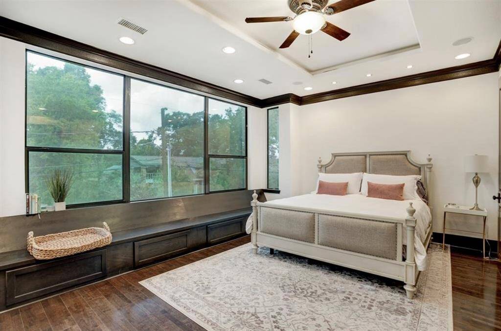 Stunning primary suite with recessed lighting, surround sound, and a quiet motorized shade upgrade.