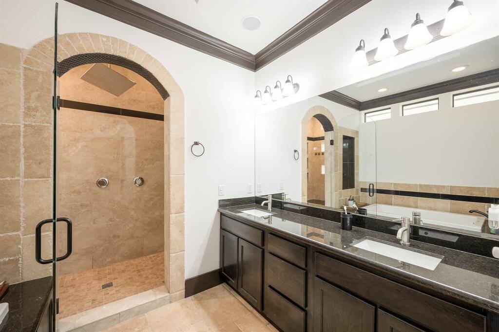 Gorgeous hollywood style bath with a jetted tub as well as a marble walk-in shower