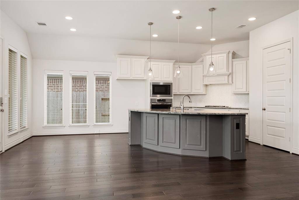 Stunning kitchen with bar seating and casual breakfast area.
