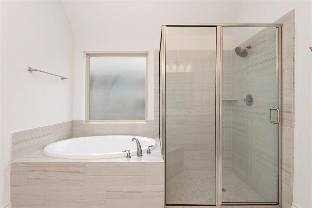 Primary ensuite with soaking tub and separate shower