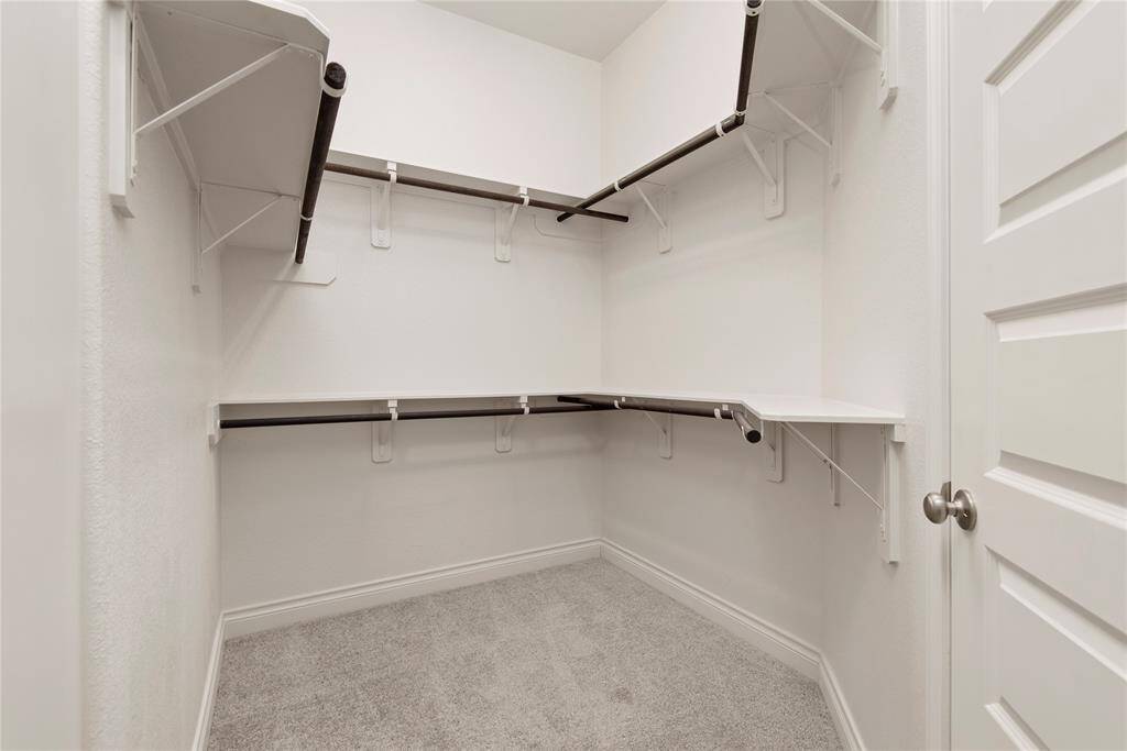 Primary bedroom walk in closet